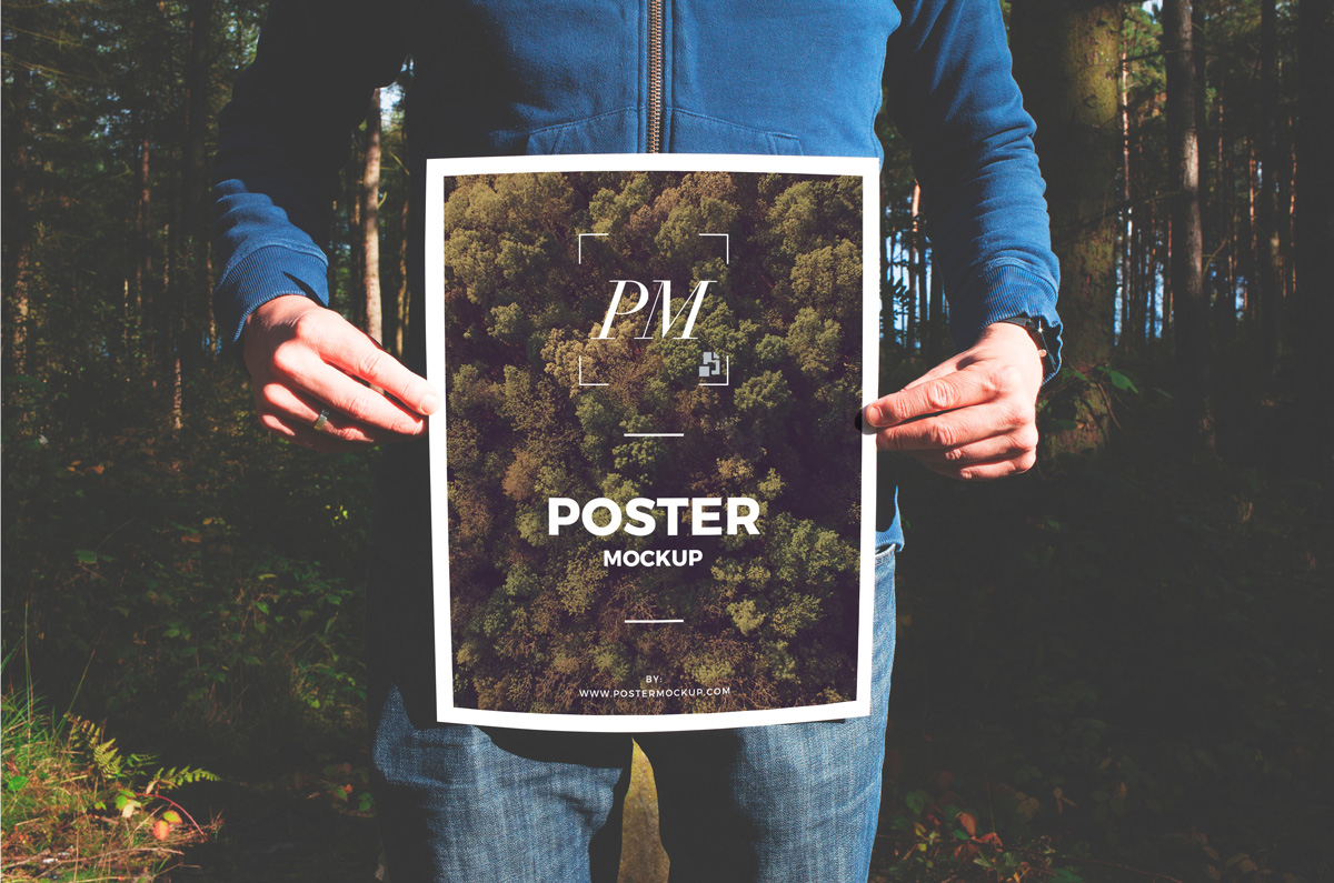 Free-Man-in-Forest-Holding-Poster-Mockup-PSD