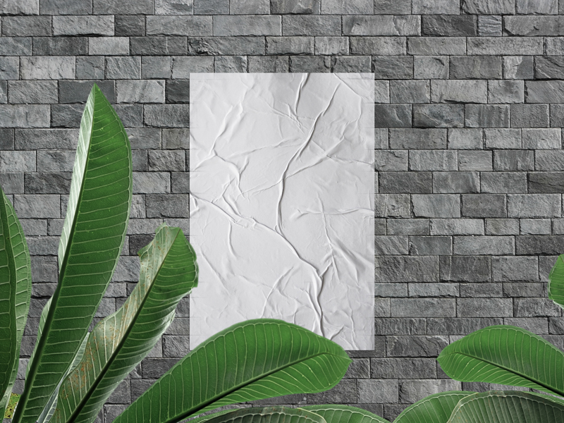 Glued-Poster-on-Stone-Wall-Mockup-With-Leaves