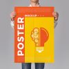 Man-Holding-Poster-Mockup-PSD-2018-300